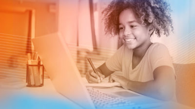 Photo of young student using remote learning software from home.