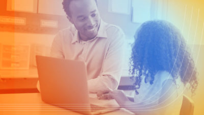 Photo of student and teacher with laptop using elearning software.