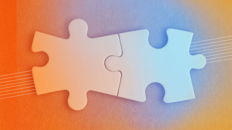 Photo of two puzzle pieces representing the relationship between UX and Market Research