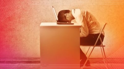 Photo showing fatigued man resting head on laptop