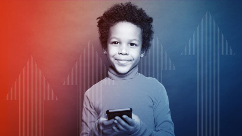 Photo of young African American boy using learning app on smartphone