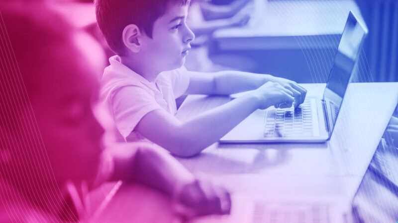 Photo of young male student using EdTech software on laptop