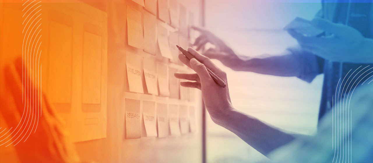 Photo of EdTech product leaders - close up of hands in a whiteboard planning session
